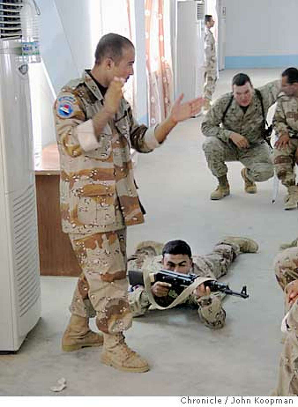 Marine Sgt. Bill Knipper conducts training in squad tactics with Iraqi commando recruits. Chronicle photo by John Koopman