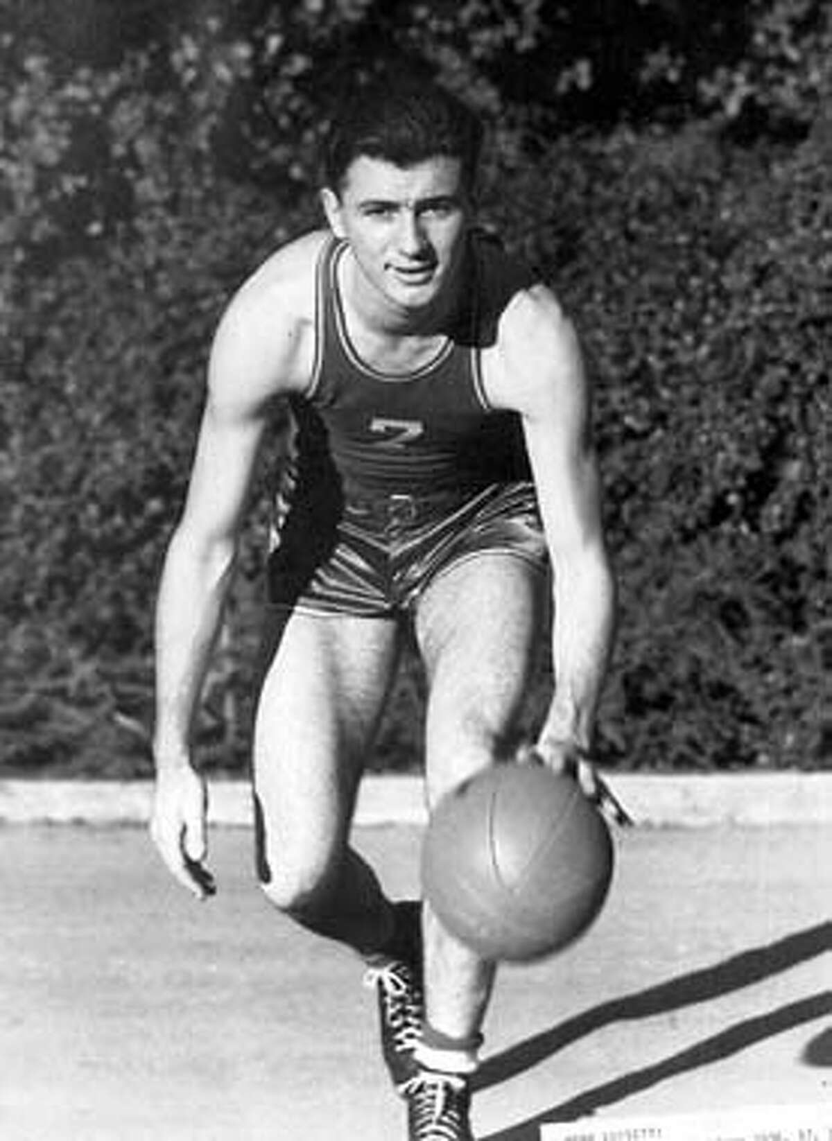 Hank Lucetti, of Stanford, Calif., University, poses with a basketball in this l940 photo. Like a lot of innovations, Hank Luisetti's pioneering one-handed set shot was born of necessity. No one knew it at the time but Luisetti had developed the precursor to the jump shot that dominates the game today. (AP Photo/Stanford University, HO)