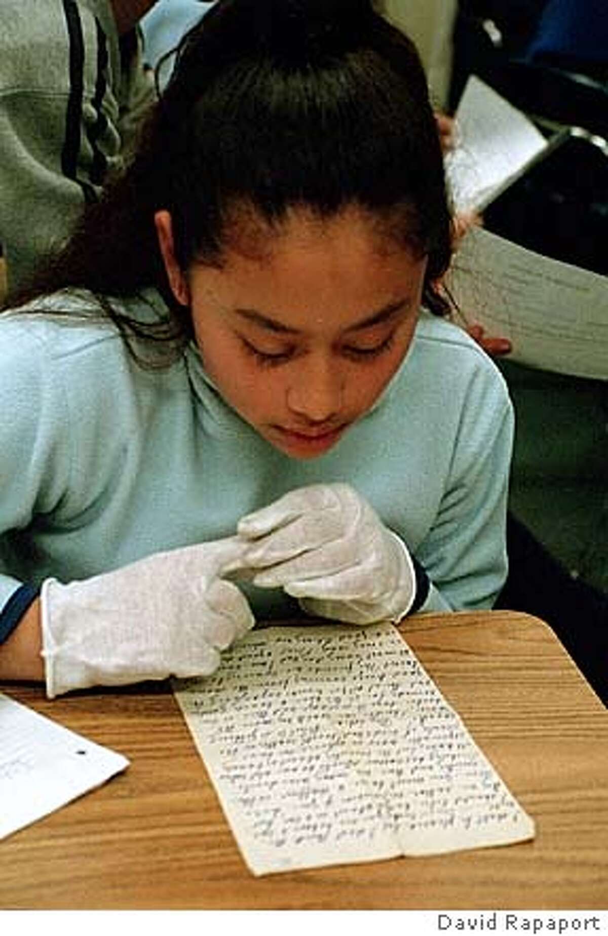 Daisy Aguilar examines one of the Julius Deetken documents. PHOTO CREDIT: DAVID RAPAPORT