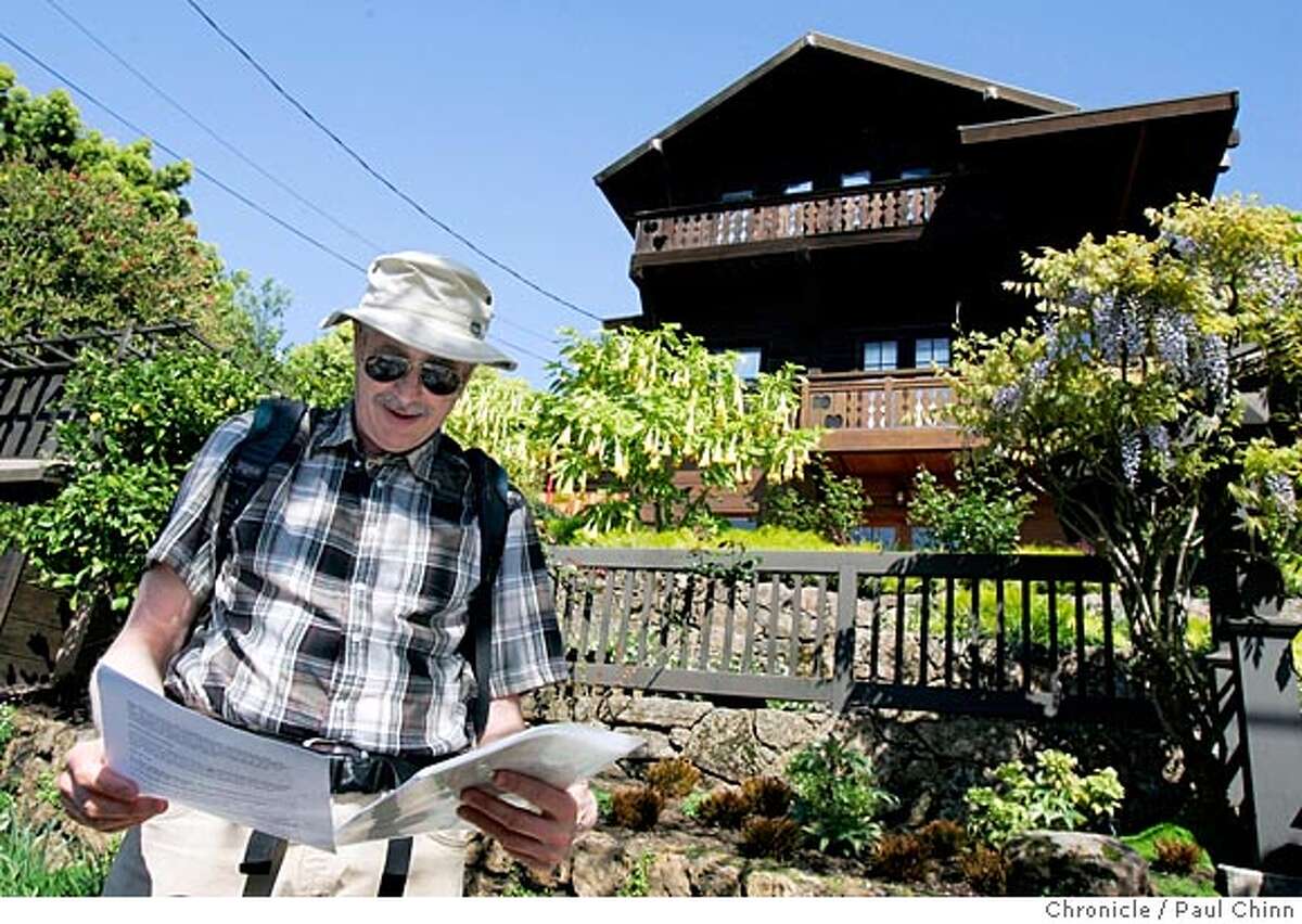 Bob Johnson reviews his notes on the Schneider-Kroeber House (right), a Bernard Maybeck-designed home at 1325 Arch St. Johnson, a member of the Berkeley Landmark Preservation Commission, toured of some of the city's most impressive architectural gems on 3/29/05 in Berkeley, CA. PAUL CHINN/The Chronicle