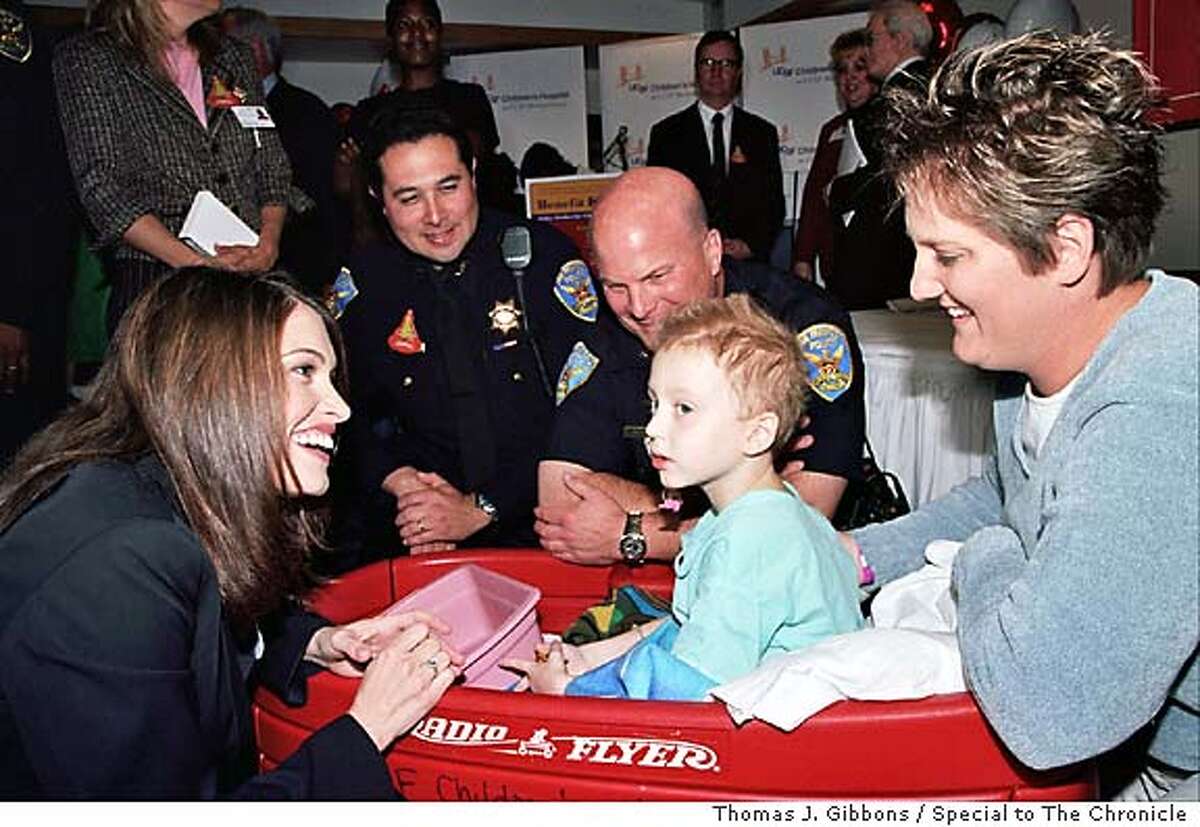 (L-R) Kimberly Guilfoyle Newsom, Deputy Chief/Administration Antonio Parra, Deputy Chief/Field Operations Greg Suhr and and Melissa Parker visit her son, Caelan Parker (7)who has received 2 liver transplants at UCSF Children's Hospital a patient at UCSF Children's Hospital. Photo by Thomas J. Gibbons / Special to The Chronicle Living#Living#Chronicle#10/10/2004#ALL#Advance#F1#0422397372