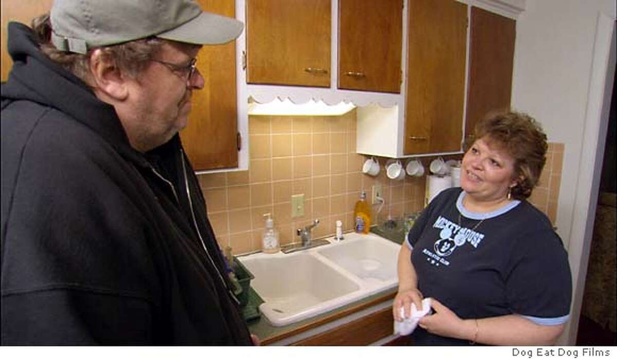 Lila Lipscomb, a mother of two veterans, in Flint, Michigan talks with filmmaker Michael Moore in a scene from Moore's new documentary film "Fahrenheit 9/11" which opens June 25, 2004 in the United States. The film takes a look at the U.S. President George W. Bush and his policies surrounding the war in Iraq and terror attacks. REUTERS/Dog Eat Dog Films/Handout