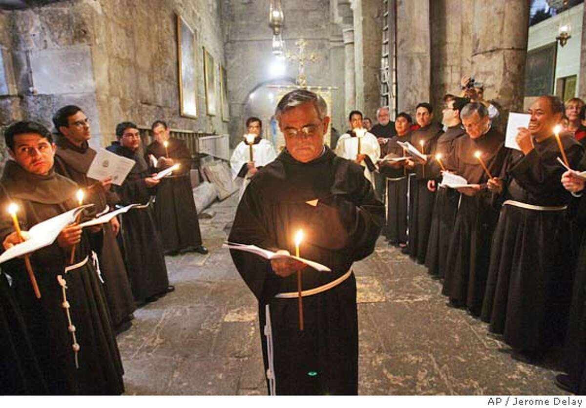 Franciscan monks participate in a Holy Saturday procession at the Church of the Holly Sepulchre in Jerusalem, Saturday March 26, 2005. (AP Photo/Jerome Delay)