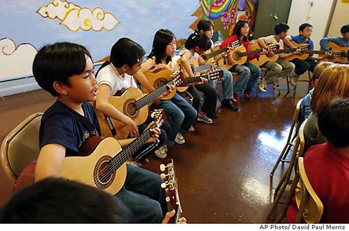 Kids who are in the Little Kids Rock program entertain and are entertained by Bonnie Raitt, Tom Waits, Norton Buffalo, Jason Newsted and Justin Willacy on October 21, 2003 at the Spring Valley Elementary School in downtown San Francisco . (AP Photo/ David Paul Morris)