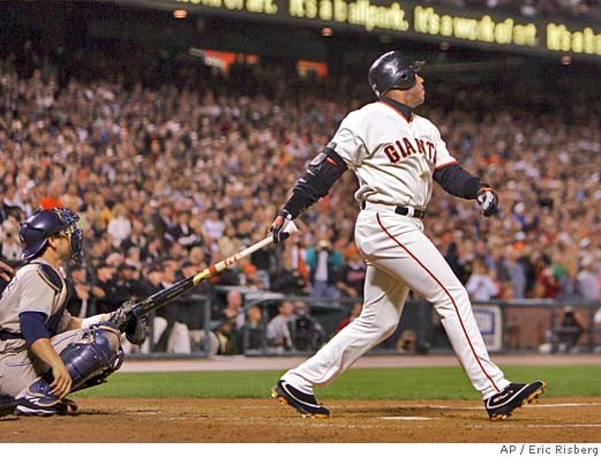 San Francisco Giants' Barry Bonds follows his 700th career home run off San Diego Padres' pitcher John Peavy during the third inning of their game in San Francisco Friday Sept. 17, 2004. At left is Padres' catcher Ramon Hernandez.(AP Photo/Eric Risberg)