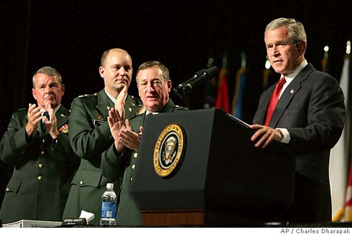 President Bush, right, is applauded by Maj. Gen. Gus Hargett, center, Col. Al Faber, second left, and Brig. Gen. Robert Taylor, left, as he speaks at the General Conference of the National Guard Association at the Las Vegas Convention Center in Las Vegas, Nev., Tuesday, Sept. 14, 2004. (AP Photo/Charles Dharapak)