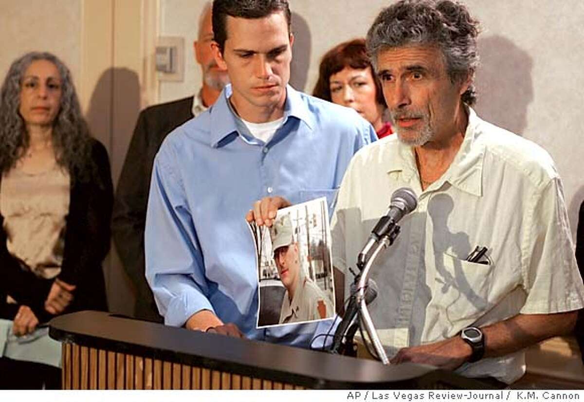 Al Zappala of Philadelphia holds a picture of his son Sgt. Sherwood Baker who was killed in Iraq during a Military Families Speak Out press conference at the Las Vegas Hilton before President Bush was scheduled to speak to the National Guard Association of the United States Tuesday, Sept. 14, 2004. Looking on is Al Zappala's son and Sgt Sherwood Baker's brother Dante Zappala and other members of Military Families Speak Out. (AP Photo/Las Vegas Review-Journal, K.M. Cannon)