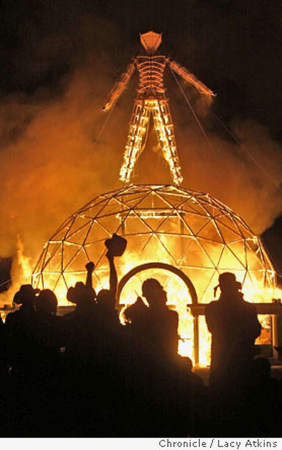 The crowd of thousands cheer as the Burning Man is burns to the ground, at the 18th annual Burning Man Celebration, Sat. Sept 4, 2004, at Black Rock Desert. People gather at Black Rock desert for the 18th annual Burning Man celebration, Saturday Sept.4, 2004, . LACY ATKINS/ The Chronicle
