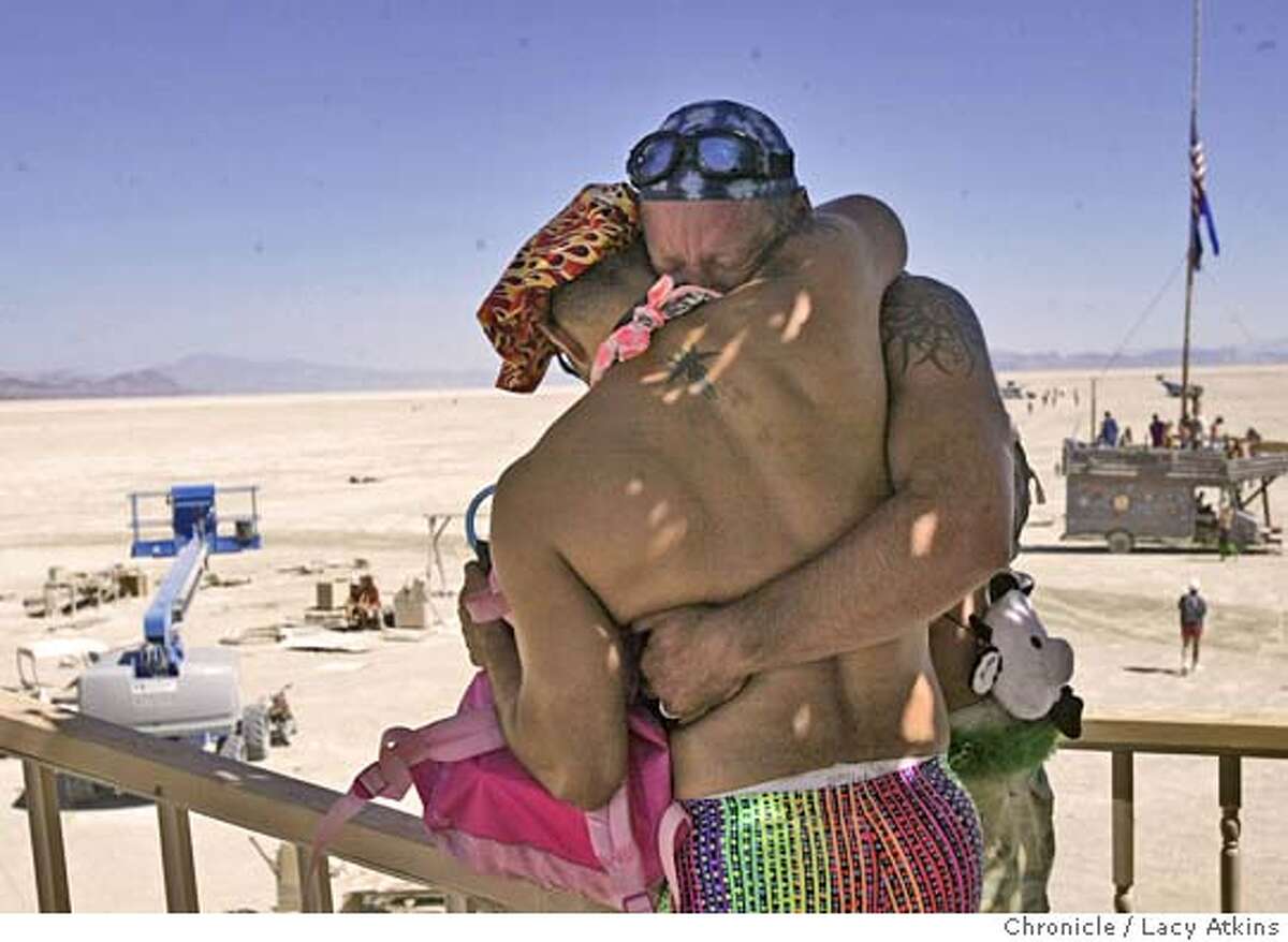 Chris Verdugo and Gene Hubert cry as they comfort each other in the Temple of Star at Burning Man , Sat. Sept. 4, 2004, in the Black Rock Desert. " This place will suck all the negative energy out of you if youi just let it", said Hubert. of People gather at Black Rock desert for the 18th annual Burning Man celebration, Saturday Sept.4, 2004, . LACY ATKINS/ The Chronicle