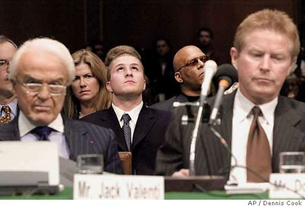 Napster founder Shawn Fanning, center, listens as the Senate Judiciary Committee holds a hearing on online entertainment Tuesday, April 3, 2001, on Capitol Hill in Washington. Jack Valenti, president of the Motion Picture Association of America, is at left and recording artist Don Henley is at right. (AP Photo/Dennis Cook) Ran on: 08-30-2004