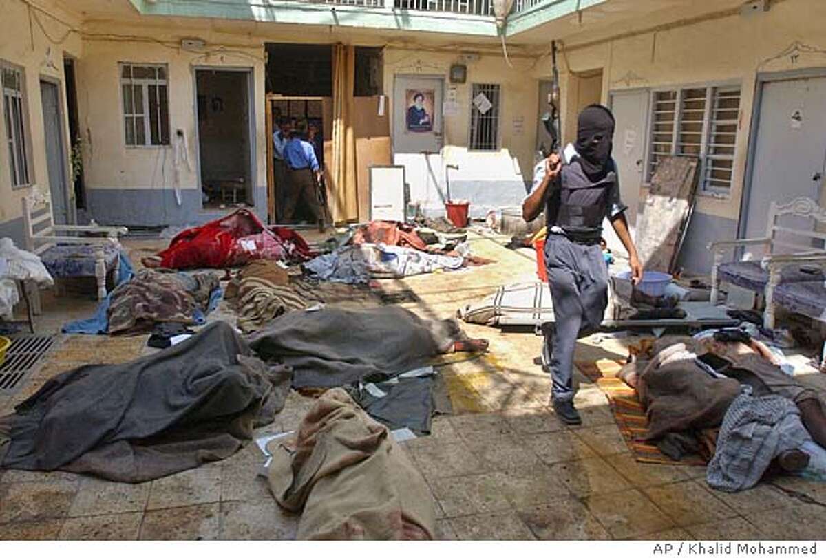 An Iraqi police officer inspects the area where about 10 bodies were discovered in a maverick religious court run by rebel Shiite cleric Muqtada al-Sadr's followers in the southern city of Najaf, Iraq Friday Friday Aug. 27, 2004. Al-Sadr's office in Najaf set up the court, which ordered arrests and meted out punishments outside of religious and legal authorities. Local Iraqi officials have in the past demanded the court be shut down and all prisoners freed. (AP Photo/Khalid Mohammed)