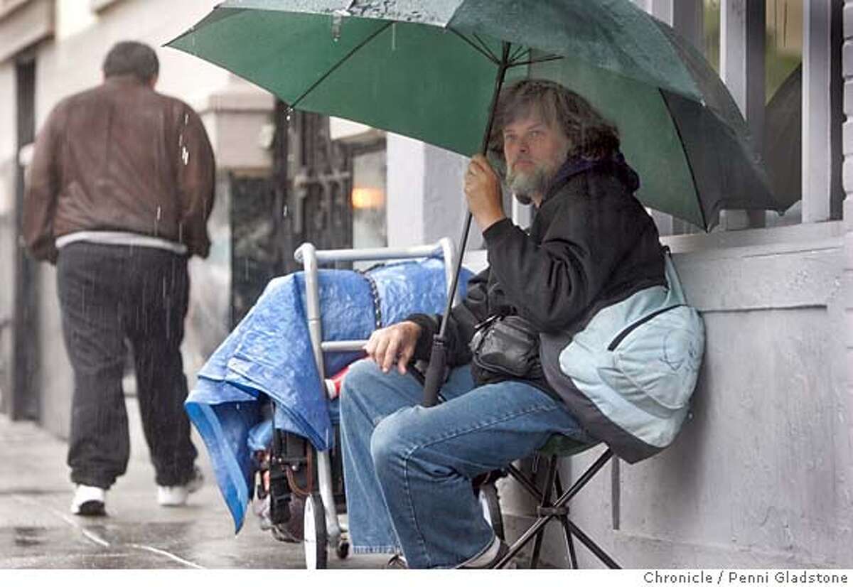 HOMELESS021PG.JPG Sitting in the rain, Robert Payne age 46 homeless for 1 yr. 3 months is from Oregon. Sleeps on street when sunny and seeks shelter other places in rain. STATs on homeless just came out. The San Francisco Chronicle, Penni Gladstone Photo taken on 2/14/05, in San Francisco,