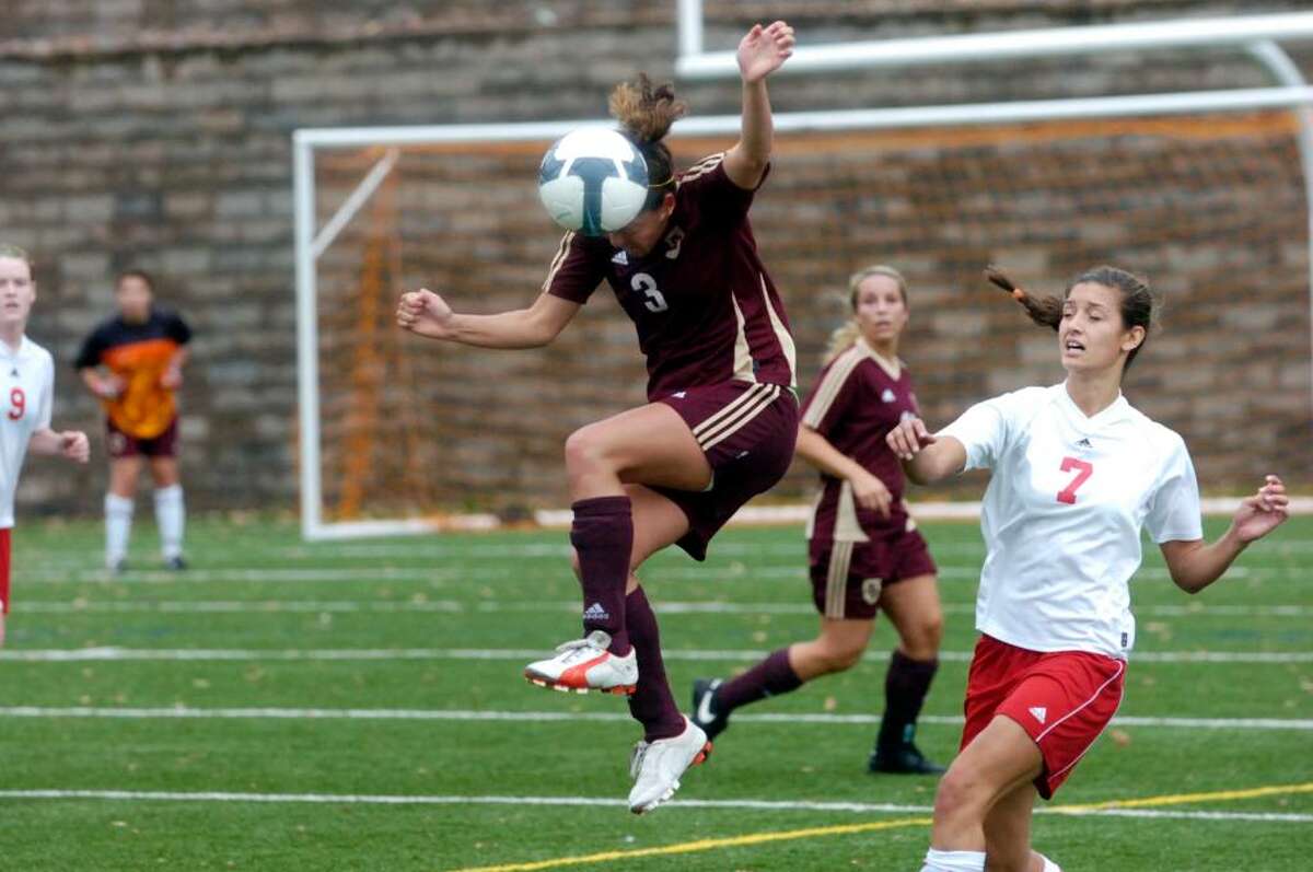 St. Joseph's Sylvia Yanez heads the ball above Greenwich's Meghan Hayden as Greenwich High hosts St. Joseph's of Trumbull in the girls soccer FCIAC quarterfinals Saturday morning, Oct. 31, 2009. Greenwich won the game.
