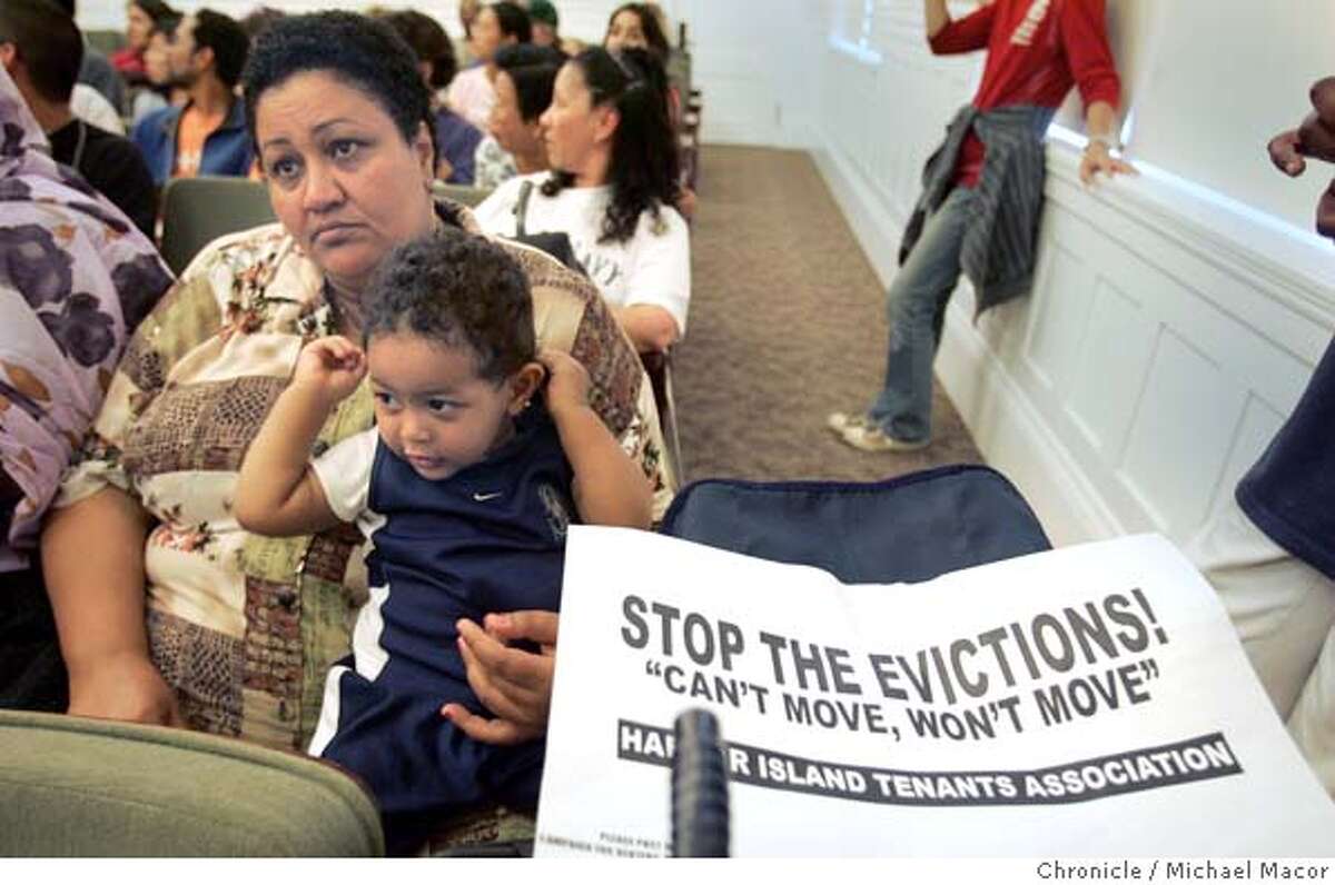 Nahwa Salih who moved into the apartments on July 12th holds her son Zouhair Mussa, 13 months waiting for the start of the Alameda City Council meeting. Alameda City Council Meeting scheduled to hear from concerned residents from the apartment complex.The developer of an apartment complex in Alameda is planning on converting the buildings to a more upscale community. The move may render many families homeless as well as displace enough children that the local school may be forced to close. 8/17/04 in Alameda Michael Macor/San Francisco Chronicle