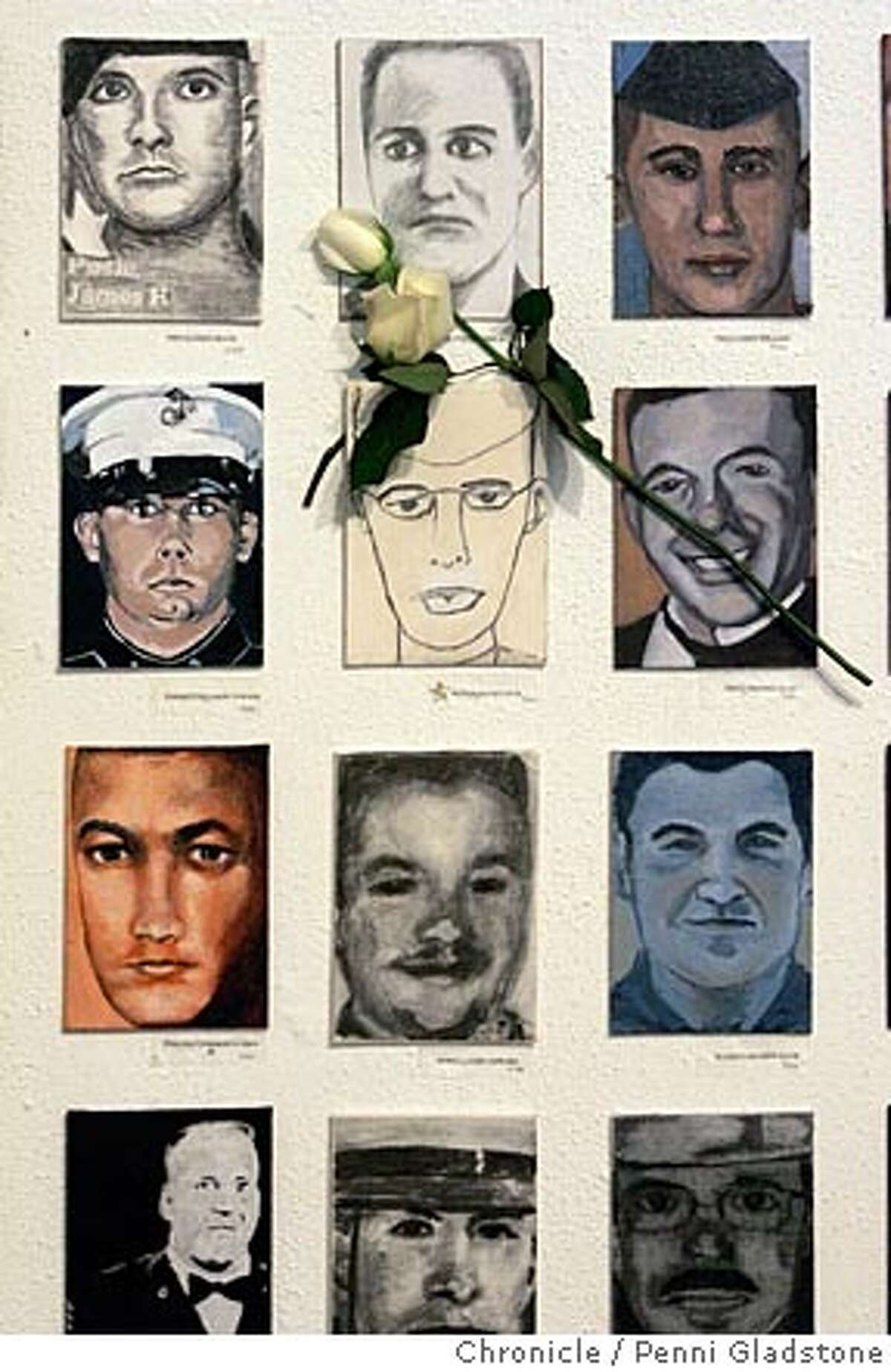 a few of the portraits in the gallery. Someone put a flower on this one. college of marin students create "faces of the fallen," a drawings and paintings art exhibition of faces of fallen soldiers to commemorate each u.s. soldier killed in iraq. exhibition is getting national attention. The San Francisco Chronicle, Penni Gladstone Photo taken on 12/17/04, in Kentfield, CA.