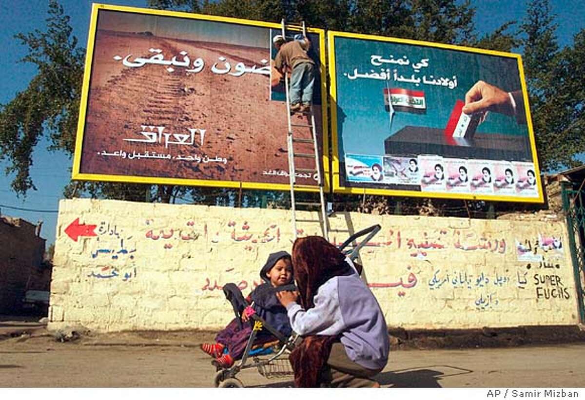 Billboard posters encouraging citizens to vote in the election, right, are replaced with others stating "They will leave and we are staying. Iraq - one country, glorious future", left, in the Karada area of central Baghdad, Iraq Thursday, Feb. 3, 2005. (AP Photo/Samir Mizban)