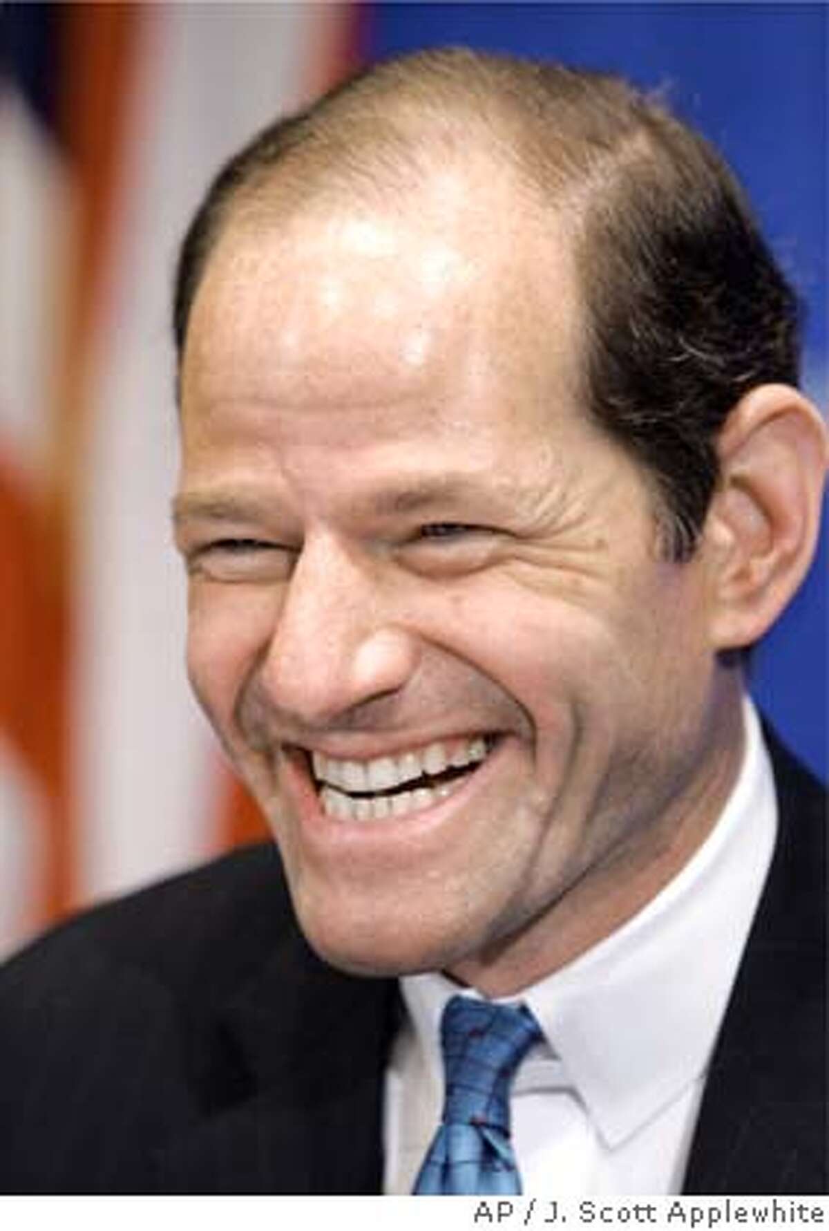 New York Attorney General Eliot Spitzer smiles before speaking at a sold-out luncheon at the National Press Club in Washington, Monday, Jan. 31, 2005. Earlier Monday, the nation's largest insurance brokerage, Marsh & McLennan Companies Inc., agreed to pay $850 million in restitution to end Spitzer's investigation into bid rigging and price fixing. (AP Photo/J. Scott Applewhite)