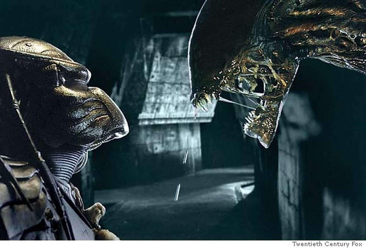 The iconic monsters from thriller franchises "Predator," right, and "Aliens," face each other on Earth in a scene from "Alien vs. Predator," in this undated promotional photo. (AP Photo/Twentieth Century Fox)