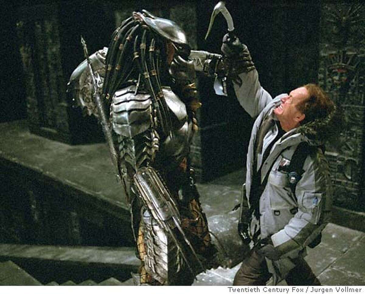 Actor Lance Henriksen--as Charles Bishop Weyland--who represents an important casting connection with the "Aliens" film franchise, battles the iconic monster from the thriller franchise "Predator," in a scene from "Alien vs. Predator," in this undated promotional photo. Henriksen, who played the android Bishop in the "Aliens" and "Alien 3" films, plays a present-day flesh and blood human in the new film that fuses the thrillers together. (Twentieth Century Fox / Jurgen Vollmer, Twentieth Century Fox)