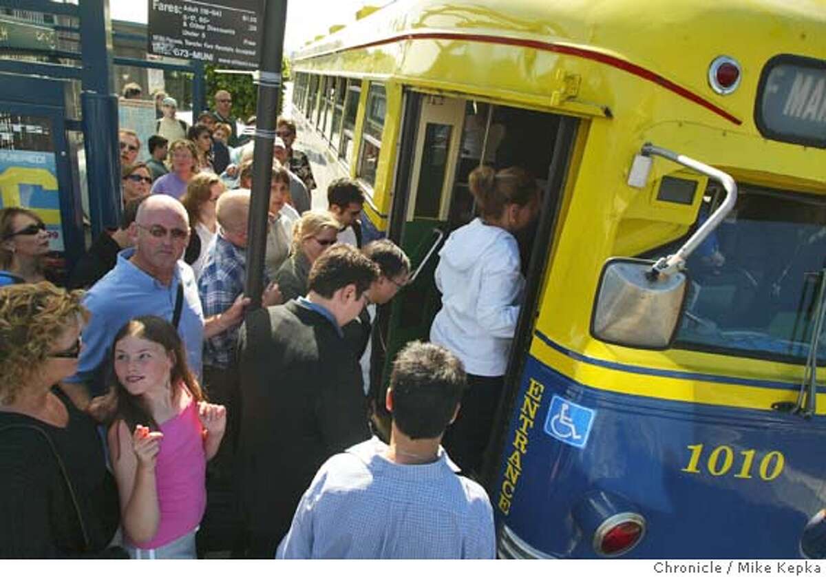 Lots of people try to fit on the F line at the Beach and Stockton stop. The F line on Muni from Fisherman's wharf to the Ferry building is packed. MIKE KEPKA/The Chronicle