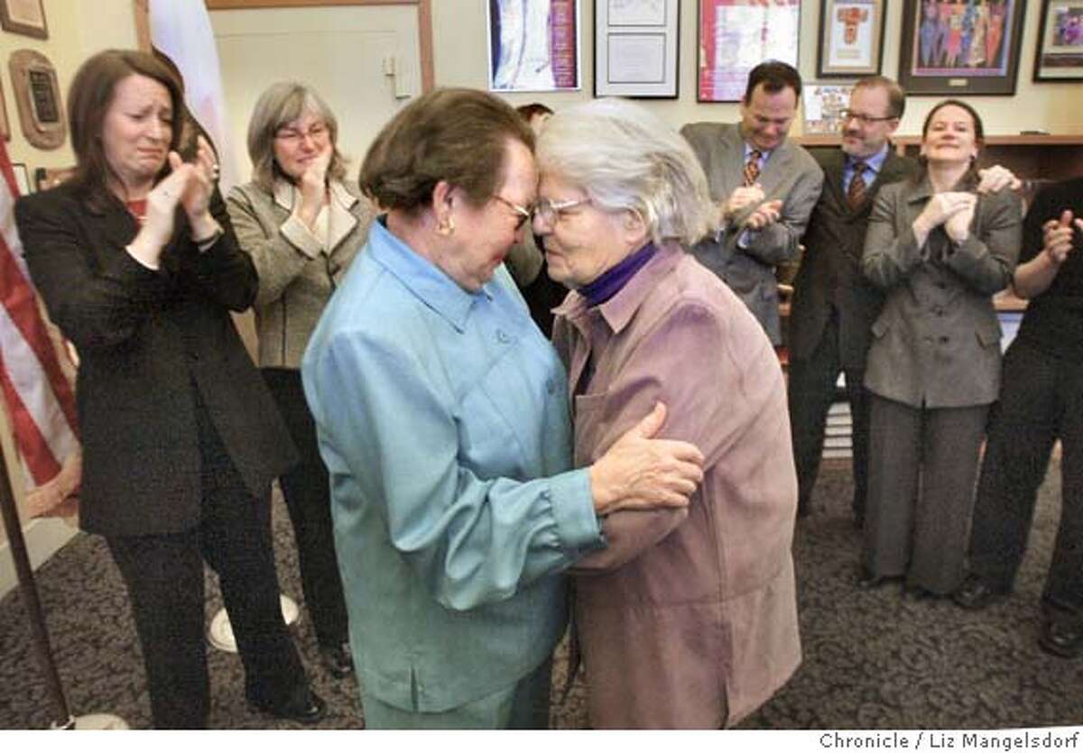 A69C0585.JPG Phyllis Lyon, left, and Del Martin, who have been together for 51 years, embrace after their marriage at city Hall. They are the first legally married same-sex couple in San Francisco. In the background from left are Kate Kendell, Executive director of the National Center for Lesbian Rights, and Roberta Achtenberg, Senior Vice President of the San Francisco chamber of Commerce. In the background on the right are members of Mayor Gavin Newsom's staff, including Steve Kawa, center, chief of Staff and Joyce Newstat, Director of Policy, far right.. The first legally married same-sex couple in San Francisco are married by City assessor/Recorder mabel Teng in her office at City Hall. Phyllis Lyon and Del Martin, who have been together for 51 years say their vows. LIZ MANGELSDORF/ The Chronicle