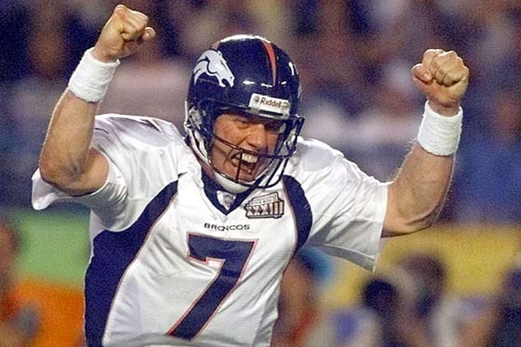 Quarterback John Elway of the Denver Broncos runs with the ball