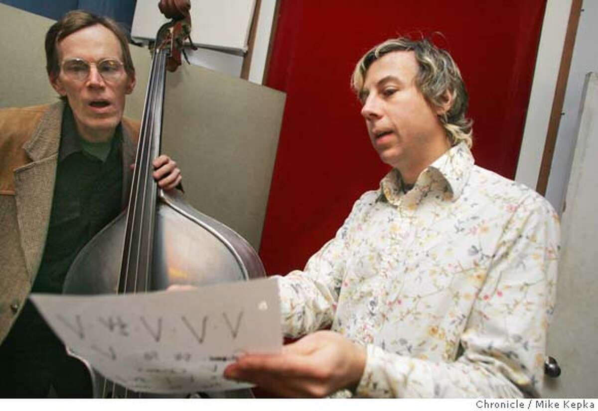 Keith Cary gets direction from John Vanderslice before recording a track at Tiny Telephone. John Vanderslice works on his own record at his studio, Tiny Telephone, in San Francisco. 1/21/05 Mike Kepka/The Chronicle