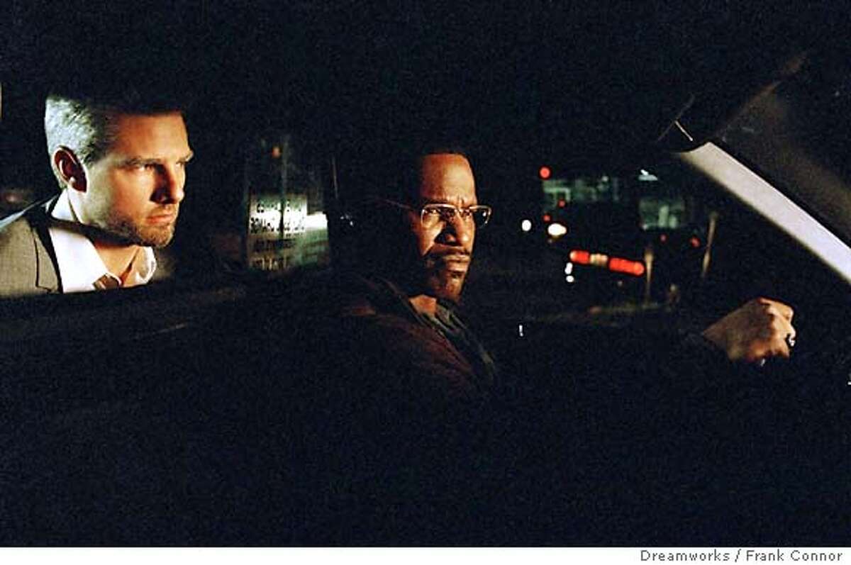 A Los Angeles cab driver Max (Jamie Foxx) is stunned to learn that his latest fare, Vincent (Tom Cruise) is a contract killer who has hijacked his cab to complete five hits in one night, in "Collateral." (Dreamworks / Frank Connor) Ran on: 08-08-2004 Michael Mann on the Collateral set with Tom Cruise and Jamie Foxx.