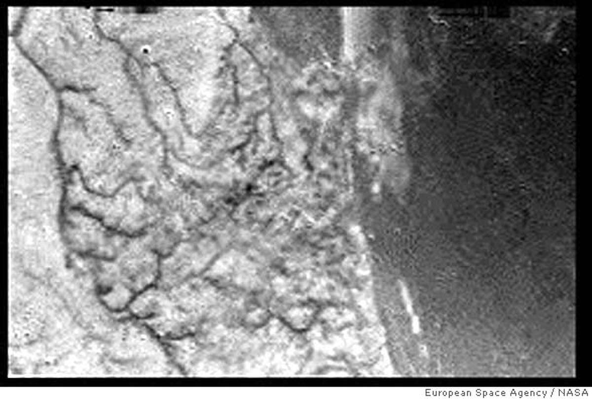 ** RETRANSMISSION TO ADD CAPTION INFORMATION ** This is a European Space Agency image from the ESA's webside taken on Friday Jan. 14, 2005, after the Huygens space probe beamed data including this image back to earth through its Cassini mothership orbiting Saturn's moon Titan. This is one of the first raw images returned by the ESA Huygens probe during its successful descent. It was taken from an altitude of 16.2 kilometers (about 10 miles) with a resolution of approximately 40 meters (about 131 feet) per pixel. It apparently shows short, stubby drainage channels leading to a shoreline. (AP Photo/European Space Agency/NASA) ** FOR EDITORIAL USE ONLY MANDATORY CREDIT: EUROPEAN SPACE AGENCY/NASA) ** RETRANSMISSION TO ADD CAPTION INFORMATION * FOR EDITORIAL USE ONLY MANDATORY CREDIT: EUROPEAN SPACE AGENCY/NASA