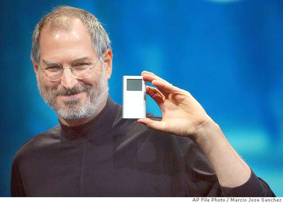 Apple CEO Steve Jobs displays his company's new product, the Mini-Ipod, at the Macworld Conference and Expo in San Francisco, Tuesday, Jan. 6, 2004. (AP Photo/Marcio Jose Sanchez) Ran on: 07-30-2004