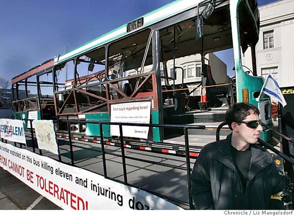 Event on 1/16/05 in Berkeley. Alex Shoykhet, Security with the Israel Action Committee of the East Bay, stands near the Bus 19 as it is on display. The Israel Action Committee of the East Bay holds a Rally against Global Terrorism at Martin Luther King Park in Berkeley. On display was Bus 19, which was blown-up by a suicide bomber Jan. 29th, 2004 in Jerusalam. Supporters of Palestinians also held a rally, mostly contained across the street from the park. Liz Mangelsdorf / The Chronicle