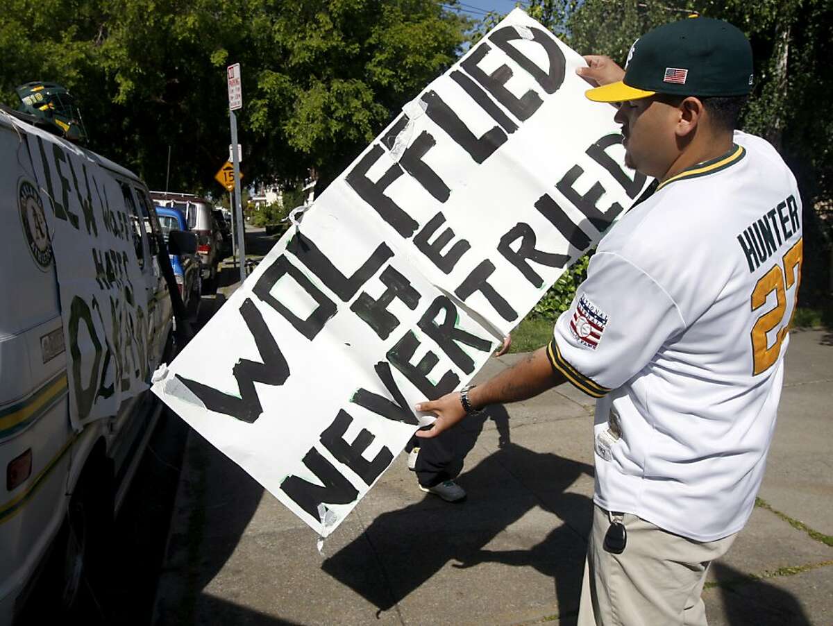 Jorge Leon holds a sign critical of Oakland A's owner Lew Wolff outside a community meeting at Peralta Elementary School to discuss ballpark options in Oakland, Calif., on Saturday, May 1, 2010. Leon was thrown out of the Coliseum by stadium security guards for displaying the sign at an A's home game.