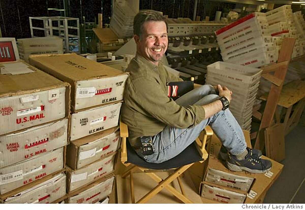 NETFLIX008.JPG Reed Hastings, Netflix's chief executive sits among boxes filled with DVDs that are being mailed out to customers, Tuesday March 2 , 2004, in San Jose Event on 3/2/04 in SAN JOSE. LACY ATKINS / The Chronicle Netflix envelopes go along a conveyor belt, above, at the companys San Jose distribution center. Reed Hastings, left, gambled on the new DVD format when he founded Netflix in 1997. MANDATORY CREDIT FOR PHOTOG AND SF CHRONICLE/ -MAGS OUT