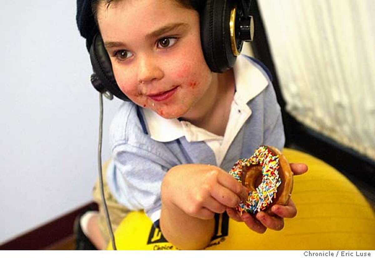 Joey Parrick,5, Petaluma, gets a unique treat, a doughnut brought by his mom while going through a session at The Swain Center in Santa Rosa for his autism. Dr. Deborah Swain, one of America�s leading experts on the Tomatis Method of therapeutic listening, recently received federal $$ to study the efficacy of this method, a treatment for learning, speech, balance, and emotional disorders. Joey Parrick,5, Petaluma going through a session at The Swain Center in Santa Rosa for his autism. Event on 6/14/04 in Santa Rosa. Eric Luse /
