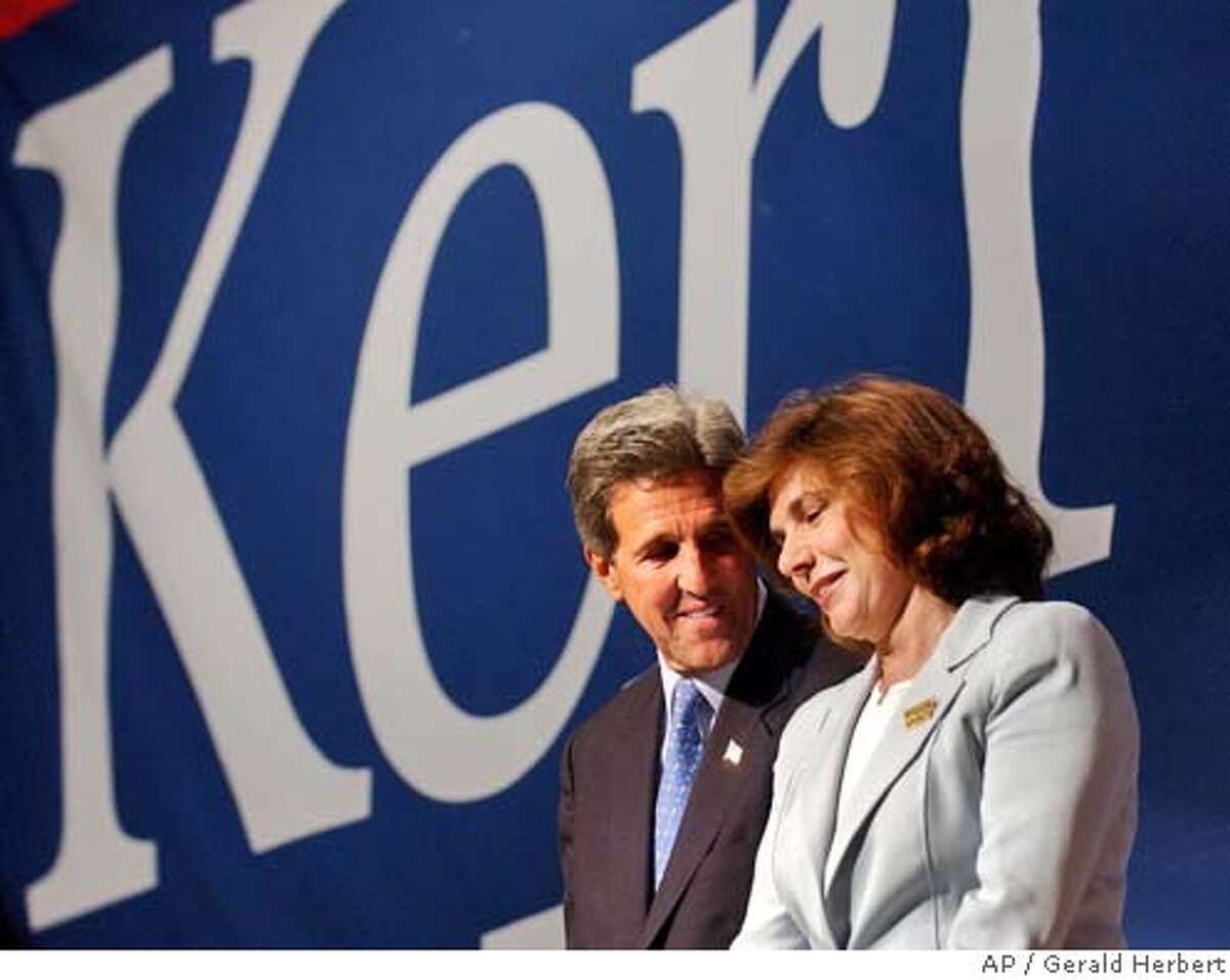 Democratic presidential candidate Sen. John Kerry, D-Mass., smiles at his wife Teresa Heinz before she speaks at the 'Women Investing in Change' luncheon in Boston Mass., Monday, July 12, 2004. (AP Photo/Gerald Herbert)