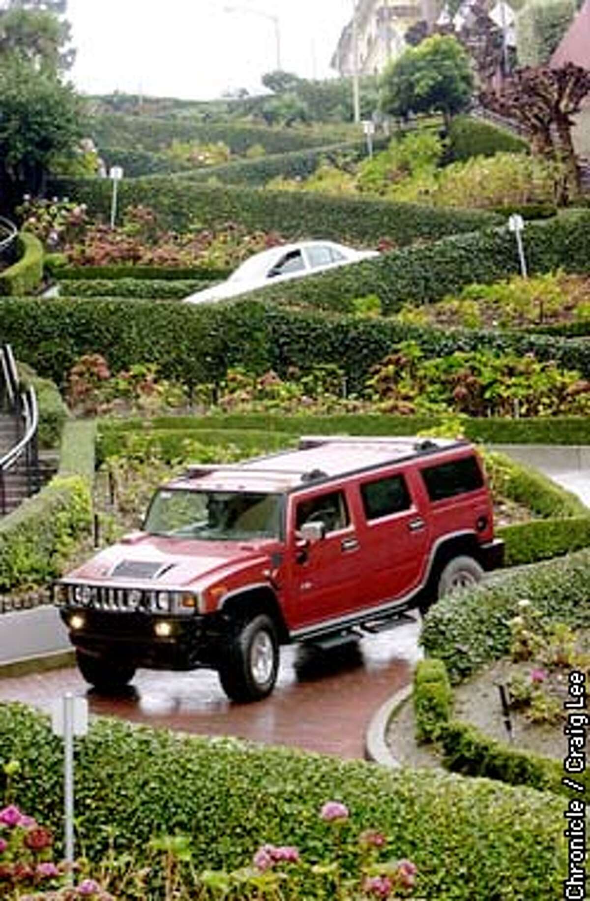 Photo of the Hummer coming down Lombard Street. Story on the popularity of the Hummer vehicle. It weighs more than three tons and is one of the least fuel efficient cars on the road. It can scale a 60 percent incline, ford small lakes, climb fallen logs and traverse boulders. General Moters is selling as many of the $50, 000 Hummer 2 urban tanks as it can make. Photo by Craig Lee
