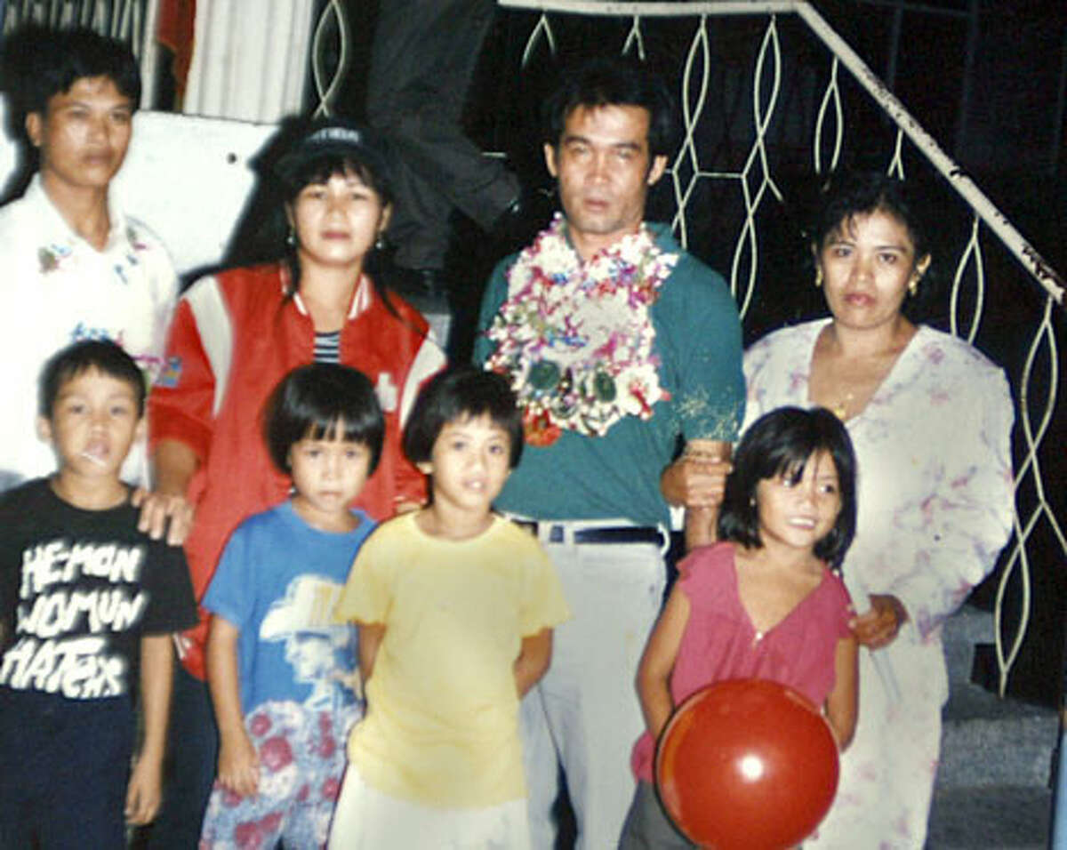 Angelo de la Cruz (middle, with leis) is seen in a photograph of family members.