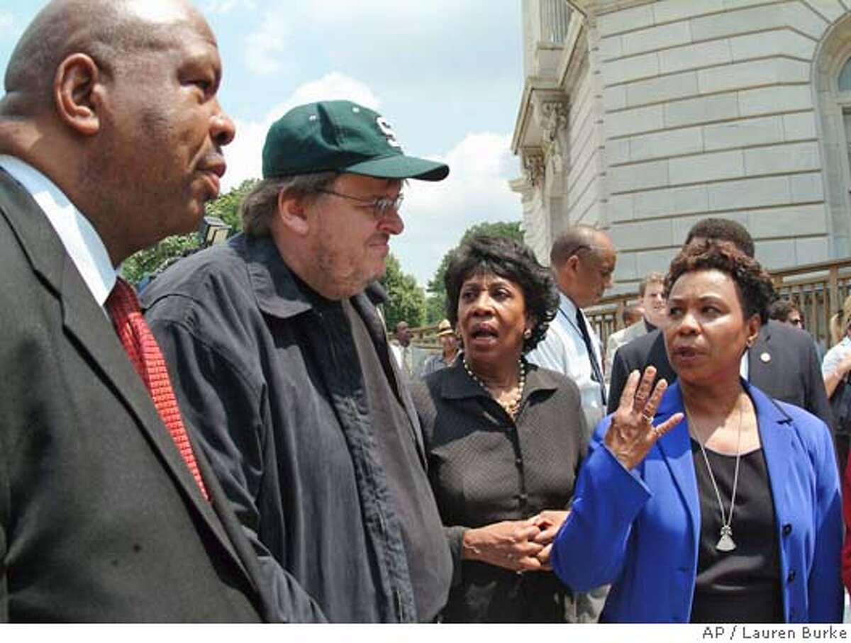 Michael Moore, director, "Farenheit 9/11," second from left, meets with members of the Congressional Black Caucus on Capitol Hill Thursday, June 24, 2004 prior to a news conference Moore was praised for his movies' exposure of what the caucus calls President Bush's propaganda machine. From left are, Caucus Chairman, Rep. Elijah Cummings, D-Md., Morre, Rep. Maxine Waters, D-Calif., and Rep. barbara Lee, D-Calif. (AP Photo/Lauren Burke)