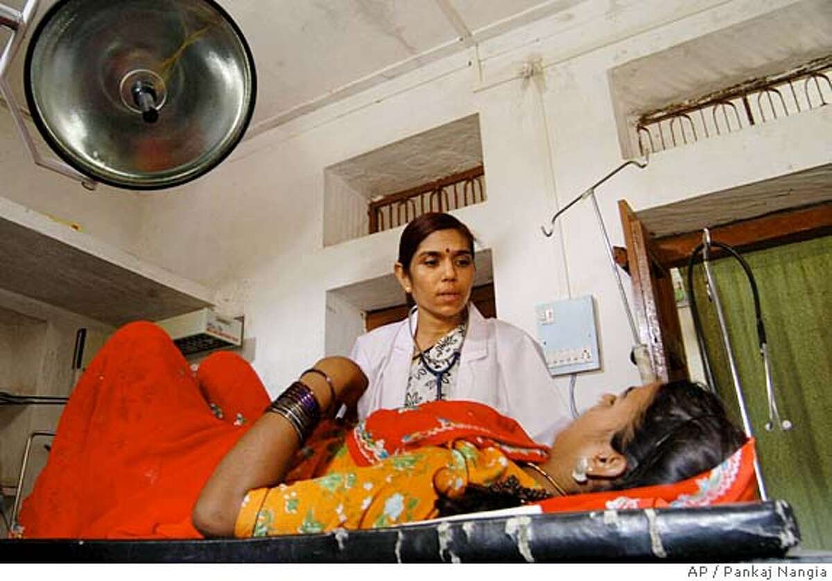 **SPECIAL FOR SAN FRANCISCO CHRONICLE** Dr. Kirti Iyengar examines a patient at the Action Research & Training for Health(ARTH) clinic at Kuncholi village 65 kilometers (41 miles) northwest of Udaipur, Saturday, July 3, 2004. (AP Photo/Pankaj Nangia)