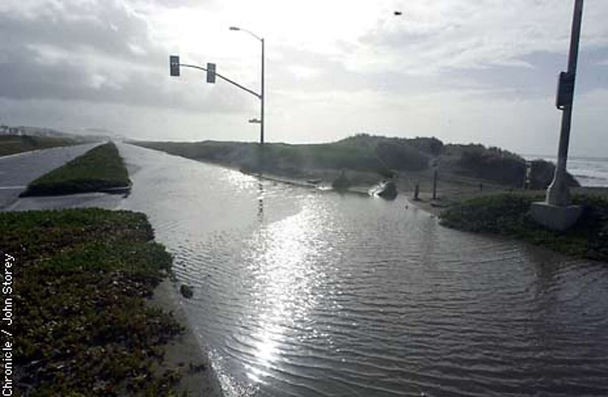 STORMS CLOSE GREAT HIGHWAY / Waves of traffic / Detouring cars clog