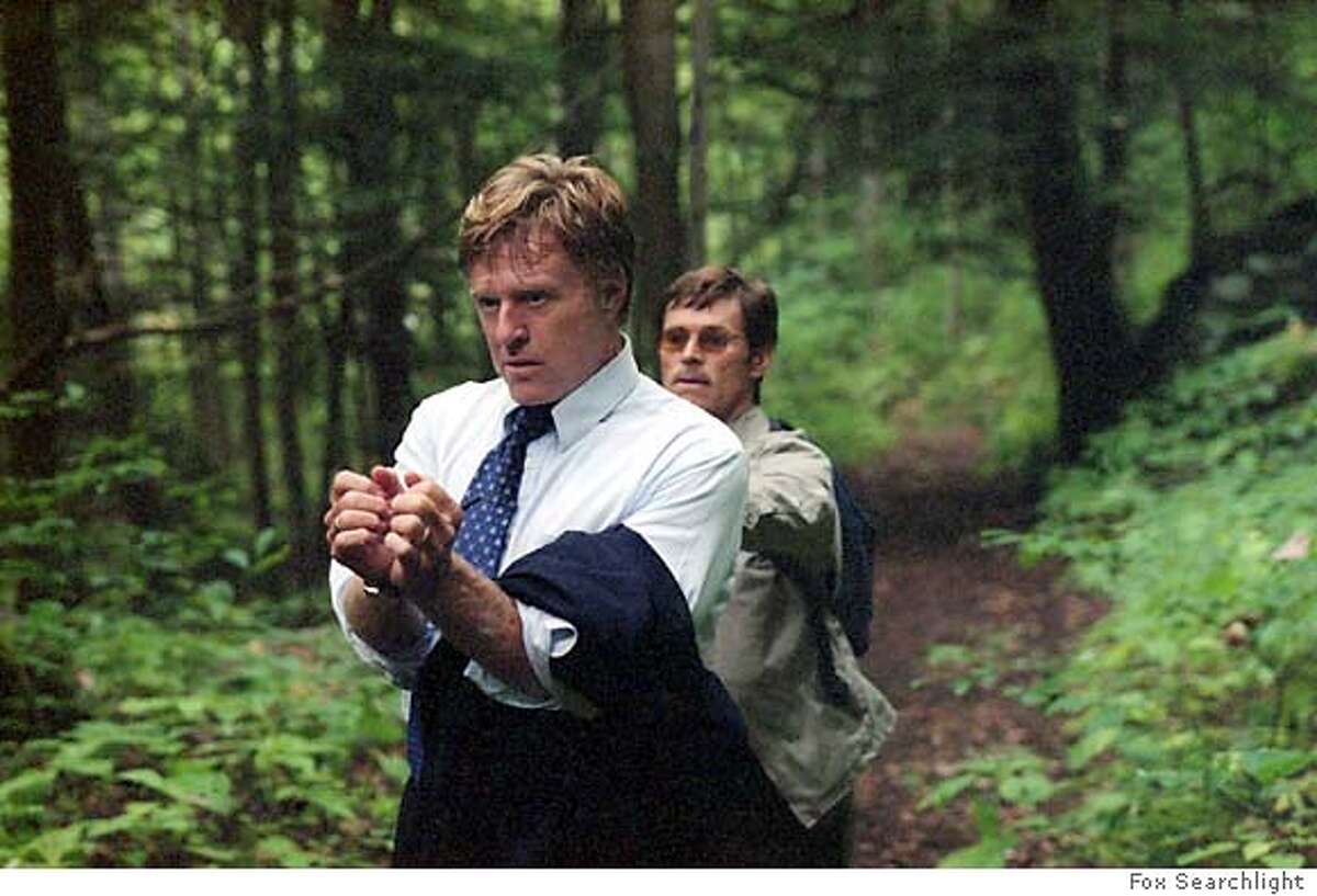 A wealthy executive (Robert Redford) is kidnapped by a disgruntled employee (Willam Dafoe) and held captive in a forest in " The Clearing." (AP Photo/Fox Serchlight)
