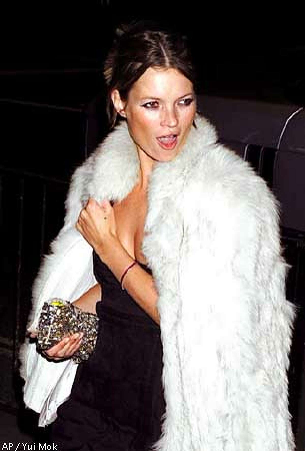 Model Kate Moss arrives at the National Portrait Gallery in London Tuesday, Jan. 29, 2002 for a private party to celebrate the launch of an exhibition of celebrity portraiture by fashion photographer Mario Testino. (AP Photo/PA, Yui Mok)