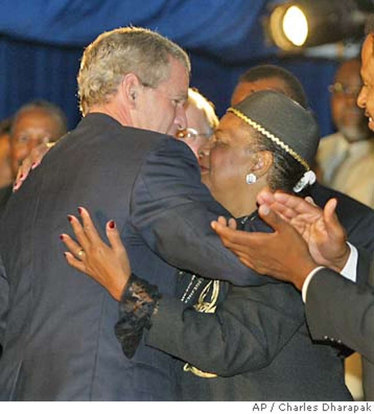 President Bush is embraced by Rev. Juanita Clark Wheeler of the God Cares Deliverance Church after Bush spoke about AIDS in Philadelphia Wednesday, June 23, 2004. (AP Photo/Charles Dharapak)