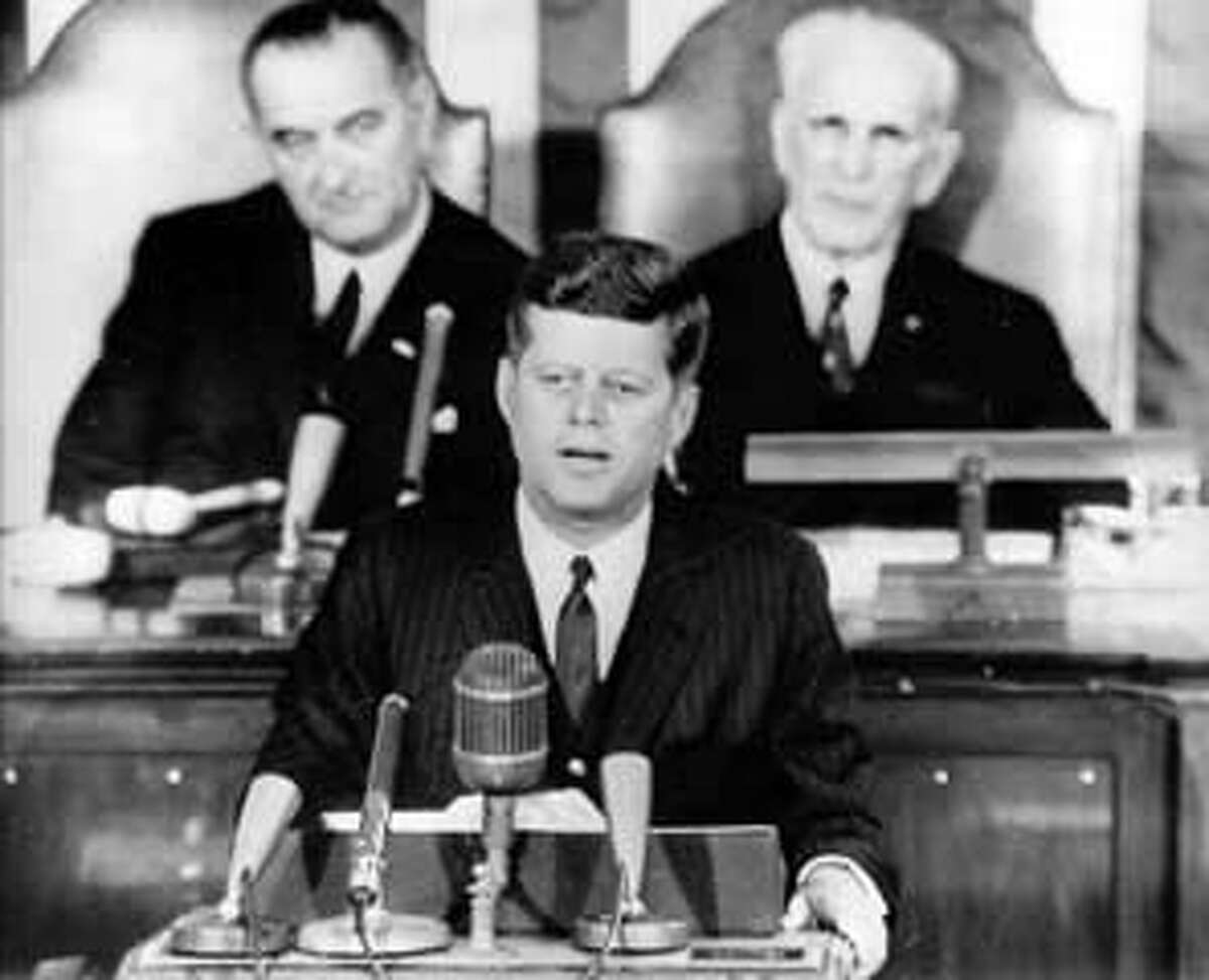 WASHINGTON,D.C.: PRESIDENT KENNEDY IS SHOWN AS HE DELIVERED HIS STATE OF THE UNION SPEECH TO A JOINT SESSION OF CONGRESS HERE 1/14. SHOWN BEHIND HIM (L) IS VICE PRESIDENT LYNDON B. JOHNSON AND (R) HOUSE SPEAKER JOHN MCCORMICK