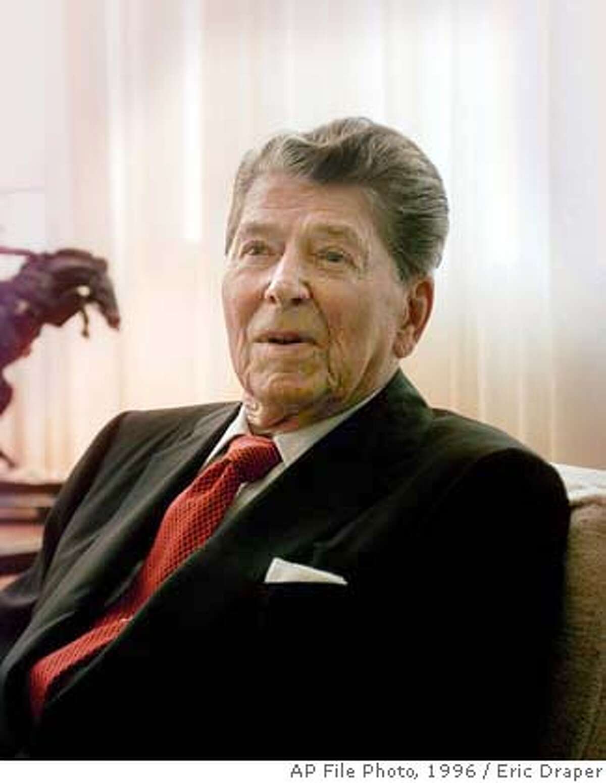 Former president Ronald Reagan sits in his office during a visit by Republican presidential hopeful Bob Dole and his wife Elizabeth, Wednesday, July 3, 1996 in Los Angeles. (AP Photo/Eric Draper)