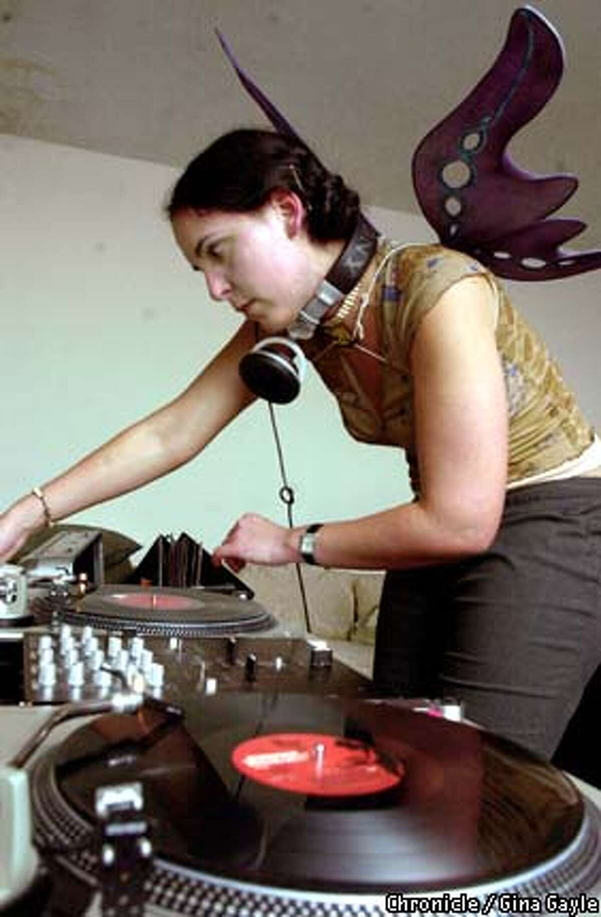 Winged for a Halloween party, Felicia Angeja -- a.k.a DJ Neta -- spins for the crowd at the Black Box. Chronicle photo by Gina Gayle