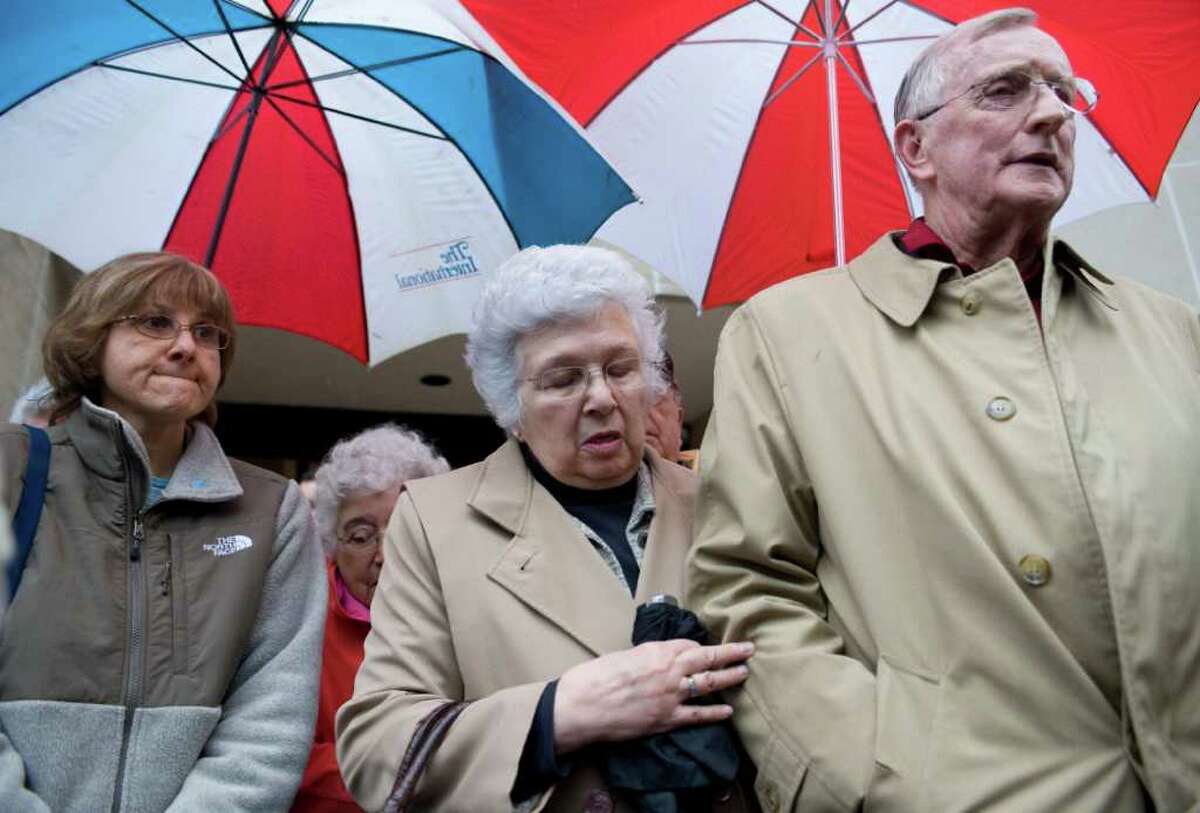 William Petit Sr., right, stands with his wife Barbara and family outside Superior Court in New Haven after the formal sentencing of Joshua Komisarjevsky in New Haven, Conn., Friday, Jan. 27, 2012. Komisarjevsky is joining co-defendent Steven Hayes on death row for the 2007 killings of Jennifer Hawke-Petit and her daughters, Hayley and Michaela, in their Cheshire home. William Petit Jr. is the sole survivor of the crime. (AP Photo/Jessica Hill)