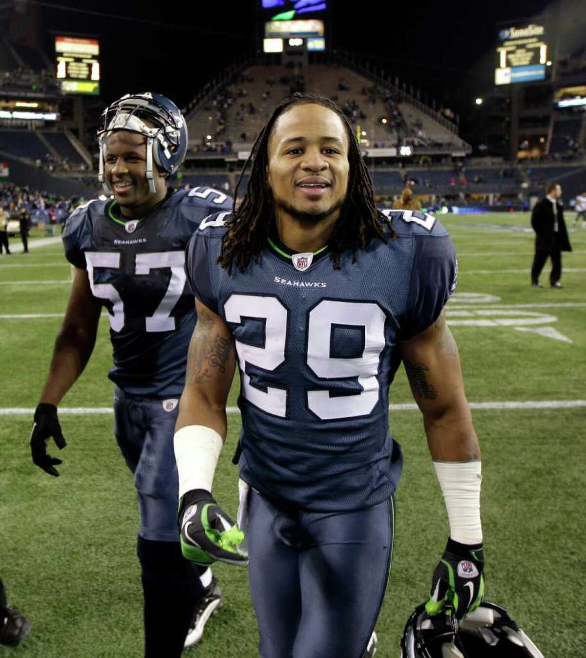 Seattle Seahawks' Earl Thomas, front, and David Hawthorne walk off the field after the Seahawks beat the Philadelphia Eagles 31-14 in an NFL football game Thursday, Dec. 1, 2011, in Seattle. (AP Photo/Ted S. Warren)