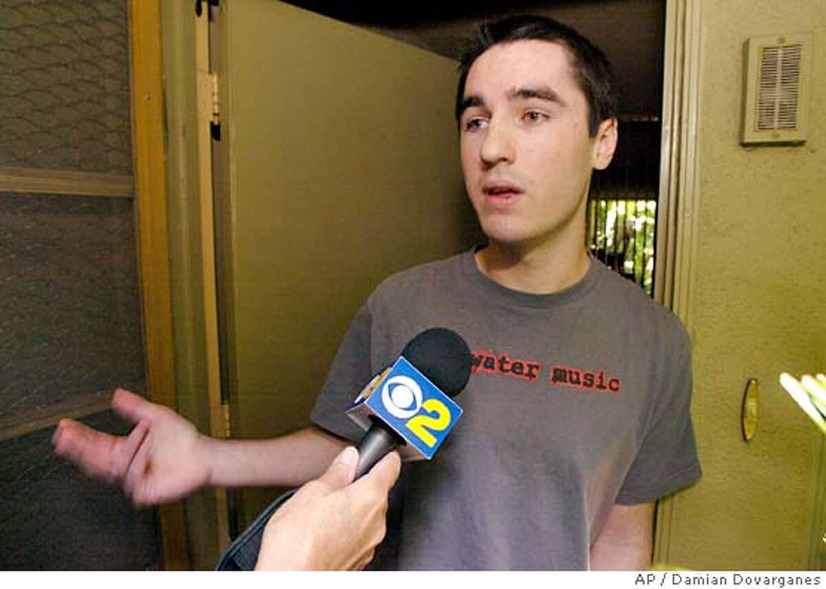 Omar Gadahn, 17, brother of Adam Yahihyi Gadahn, who was named Wednesday as one of seven suspected al-Qaida operatives sought by the FBI, expresses his disbelief to members of the media Wednesday, May, 26, 2004, as he opens his home front door in Santa Ana, Calif. Family members who lost contact several years ago with the Adam Yahihyi Gadahn, were stunned by the FBI's announcement. "I don't believe it, but I don't know. Anything is possible," said his brother, Omar Gadahn. "He wanted to follow what he believed and that's what he did." (AP Photo/Damian Dovarganes)