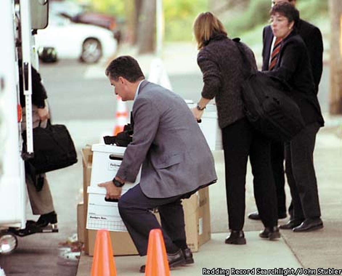 Federal Bureau of Investigation agents carry boxes of evidence stemming from the investigation into Dr. Chae Moon, a cardiologist from Redding Medical Center and Dr. Fidel Realyvasquez, Jr., chairman of the cardiac care program, for allegedly overprescribing procedures on patients in Redding, Calif. Wednesday Oct. 30, 2002. On Thursday, stock in Tenet Healthcare Corp., the company that owns the Redding hospital, dropped by 25 percent after investors learned of the FBI investigation at the hospital. (AP Photo/Redding Record Searchlight, John Stubler)